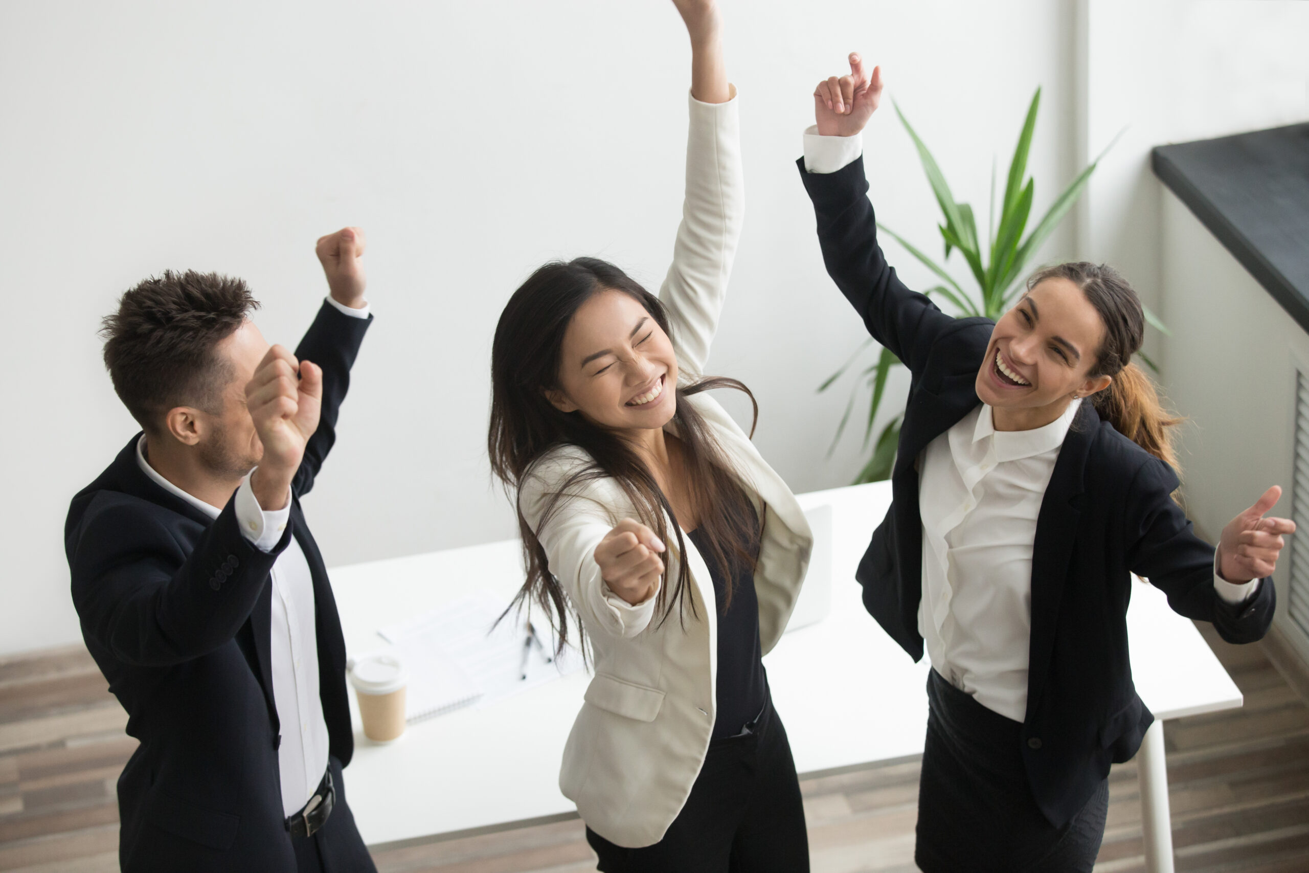Victory dance concept, excited diverse coworkers celebrating business success, unbelievable achievement triumph, happy euphoric team colleagues jumping dancing in office enjoying great win, top view